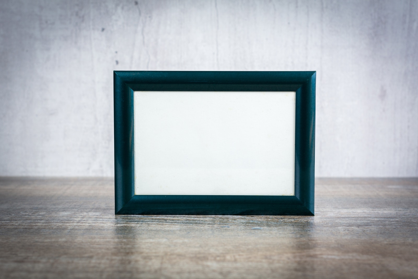 blue wooden frame on brown wooden table